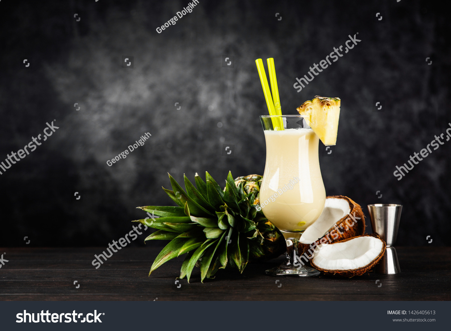 Piña colada cocktail with pineapple and coconut on a dark moody background