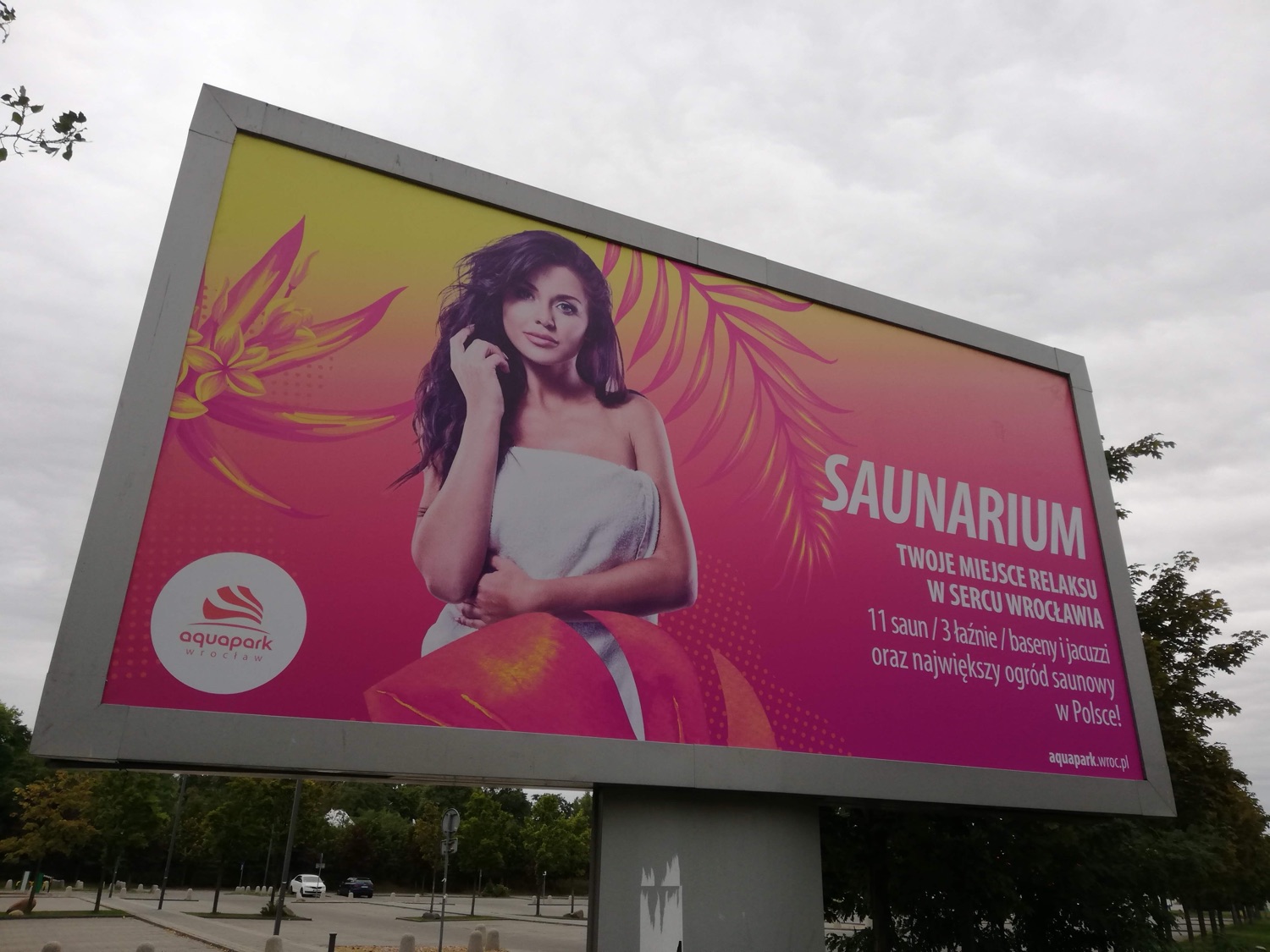 My photography on a pink-and-yellow Aquapark Wrocław 'Saunarium' billboard